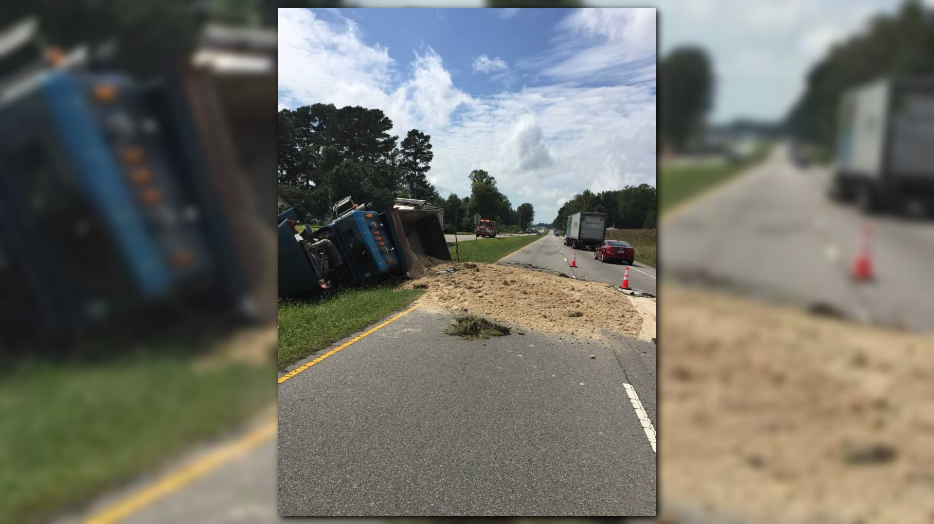 Driver facing charges after dump truck overturns, spills sand, dirt all ...